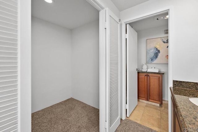 a bed room with a bed and a chair