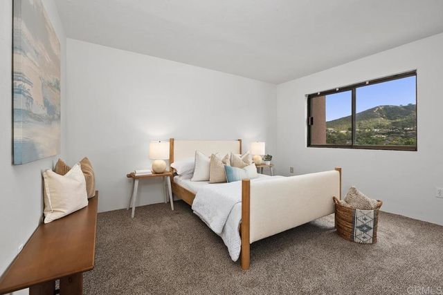 a bedroom with a bed and a lamp