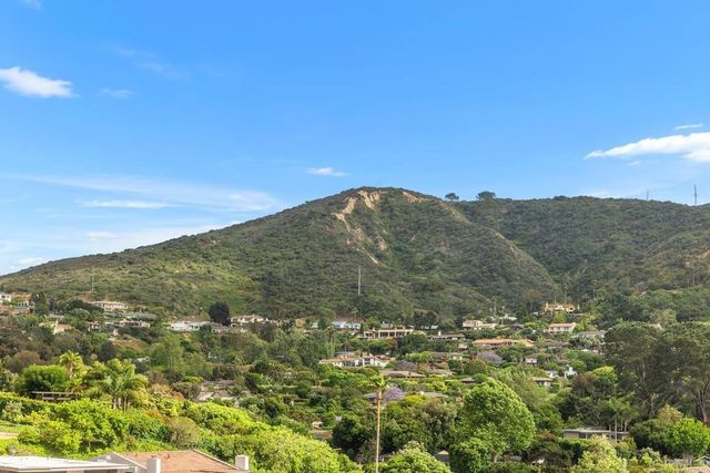 a bathroom with a granite countertop sink a toilet a mirror and shower