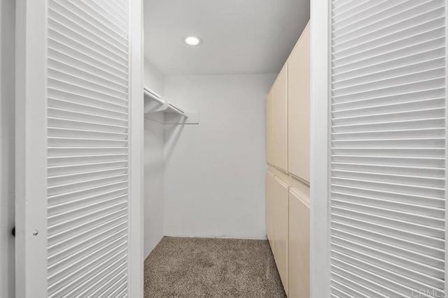 a living room with couch and a floor to ceiling window