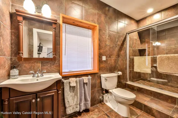 a bathroom with a sink toilet and shower
