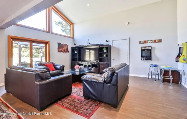 a living room with furniture windows and a flat screen tv