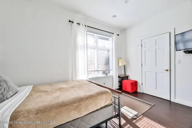 a bedroom with a bed and a window