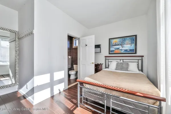 a bedroom with a bed and a dresser