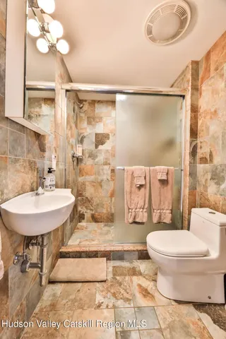 a bathroom with a sink toilet and shower