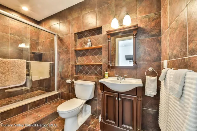 a bathroom with a sink toilet and mirror