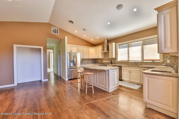 a kitchen with a sink cabinets and wooden floor