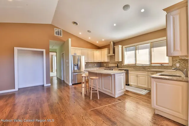 a kitchen with a sink cabinets and wooden floor
