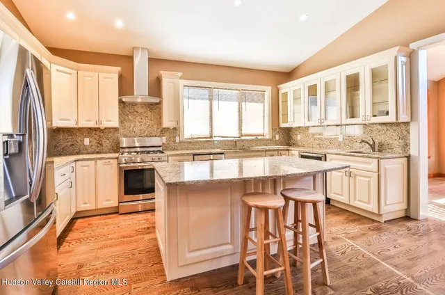 a kitchen with a stove a sink and a refrigerator