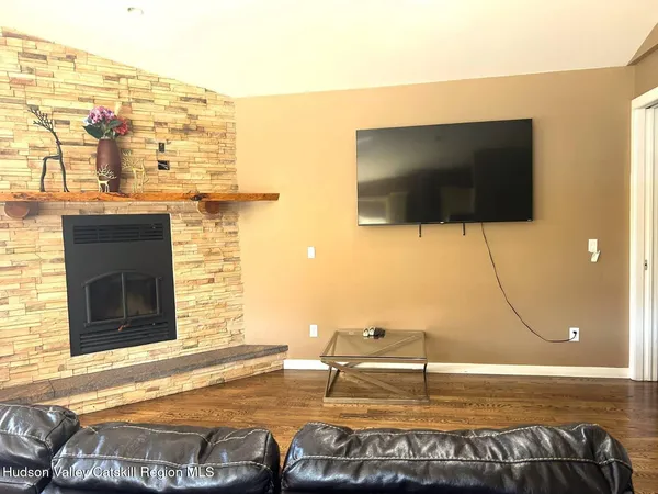 a living room with a flat screen tv and a floor to ceiling window