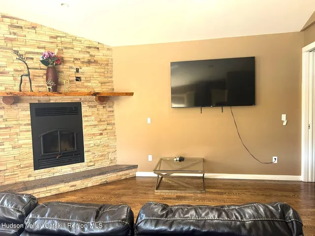 a living room with a flat screen tv and a floor to ceiling window