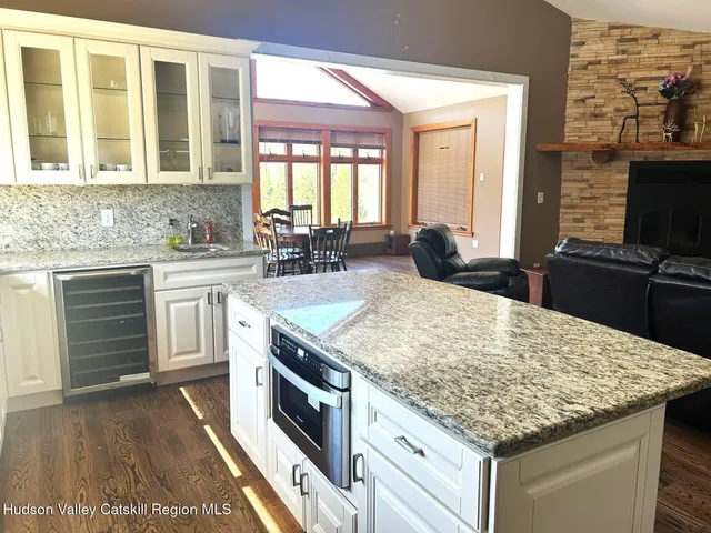 a kitchen with a stove and a wooden floor