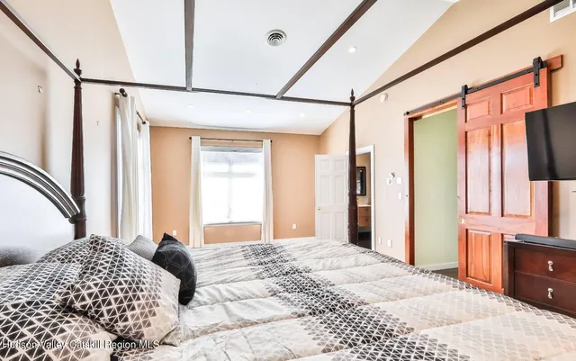 a bedroom with a bed window and walk in closet