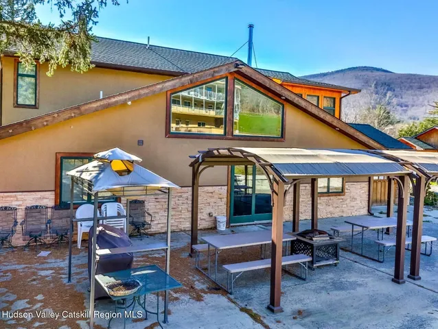 a view of patio with a table and chairs under an umbrella