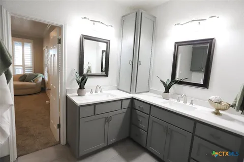 a bathroom with a double vanity sink and mirror