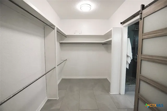 a kitchen with stainless steel appliances kitchen island granite countertop a sink wooden cabinets and a granite counter tops