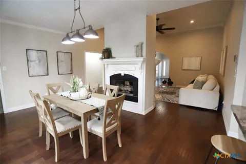 a view of a dining room with furniture wooden floor and chandelier