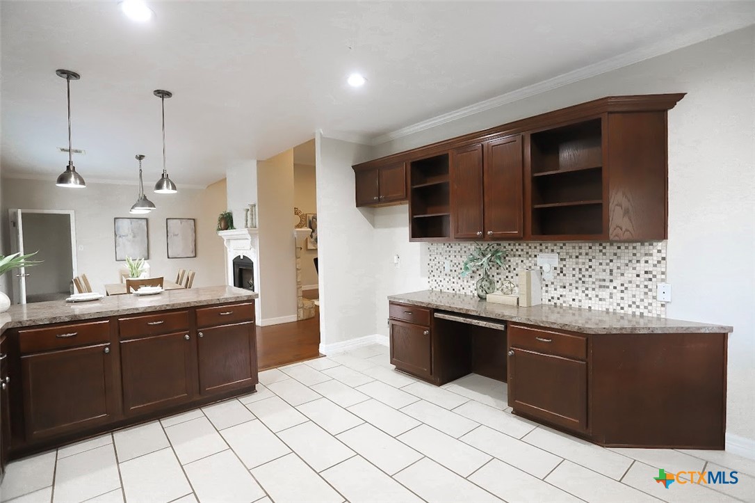 1701 Sulpher Wells Road Salado, TX 76571 - Photo 19 of 34 a kitchen with stainless steel appliances kitchen island granite countertop a sink and a stove top oven with wooden floor