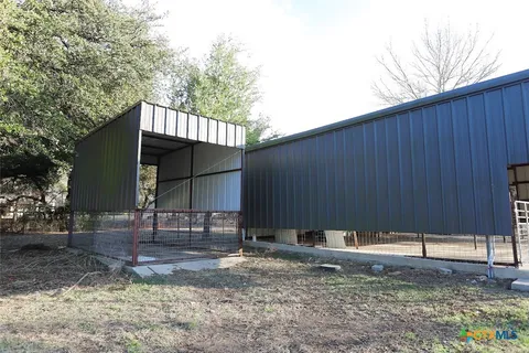 a backyard of a house with barbeque oven