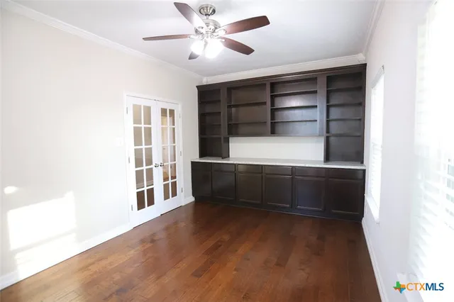 a spacious bedroom with two beds and a chandelier