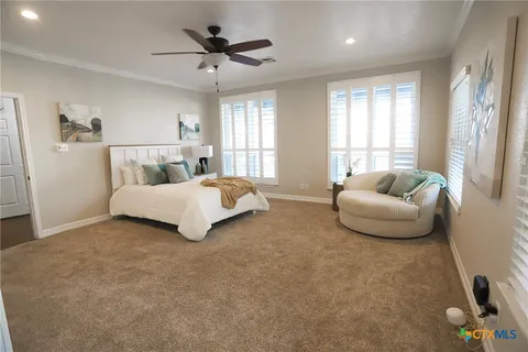 a spacious bedroom with a bed and a couch