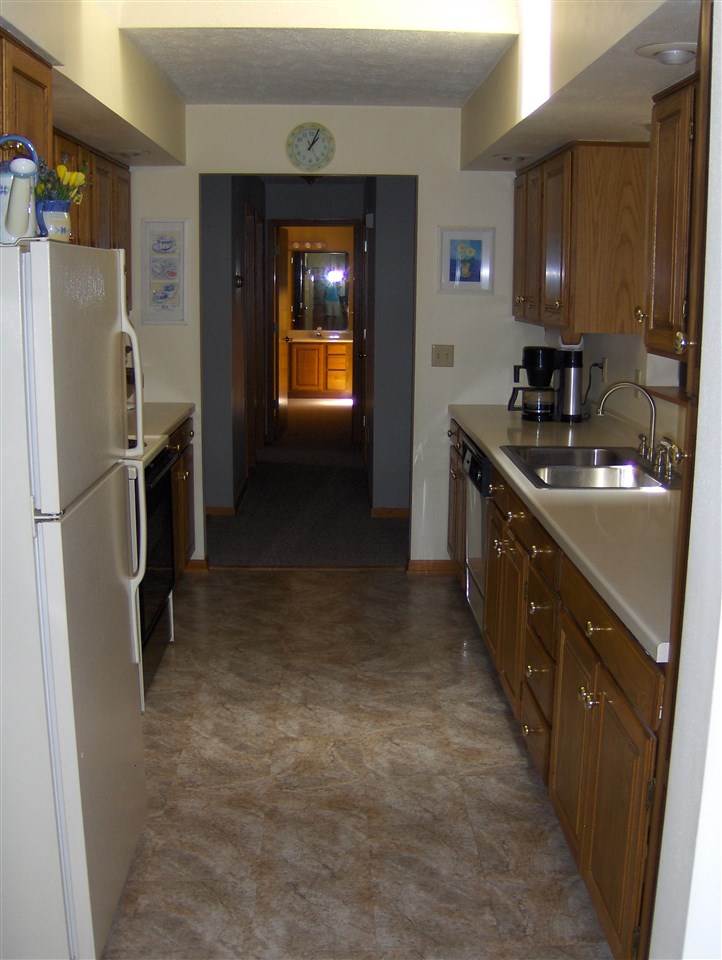 606 Berglund Road Pecatonica, IL 61063 - Photo 3 of 20 a kitchen with stainless steel appliances granite countertop a refrigerator a stove and a sink