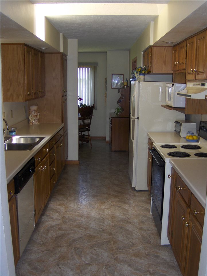 606 Berglund Road Pecatonica, IL 61063 - Photo 4 of 20 a kitchen with kitchen island granite countertop a sink stove and refrigerator