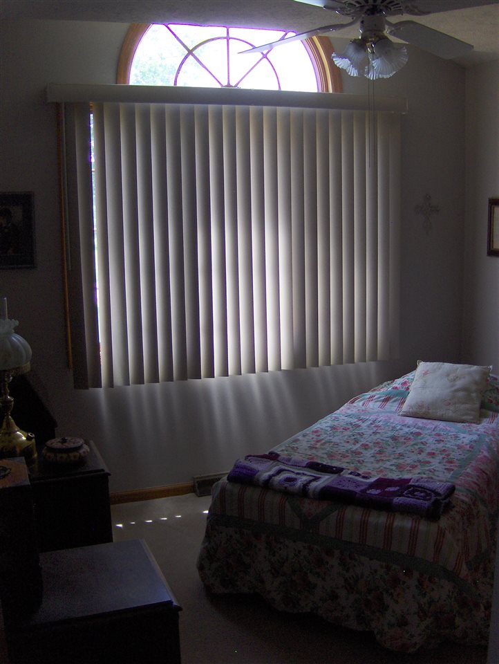606 Berglund Road Pecatonica, IL 61063 - Photo 10 of 20 a bedroom with a bed and a chandelier