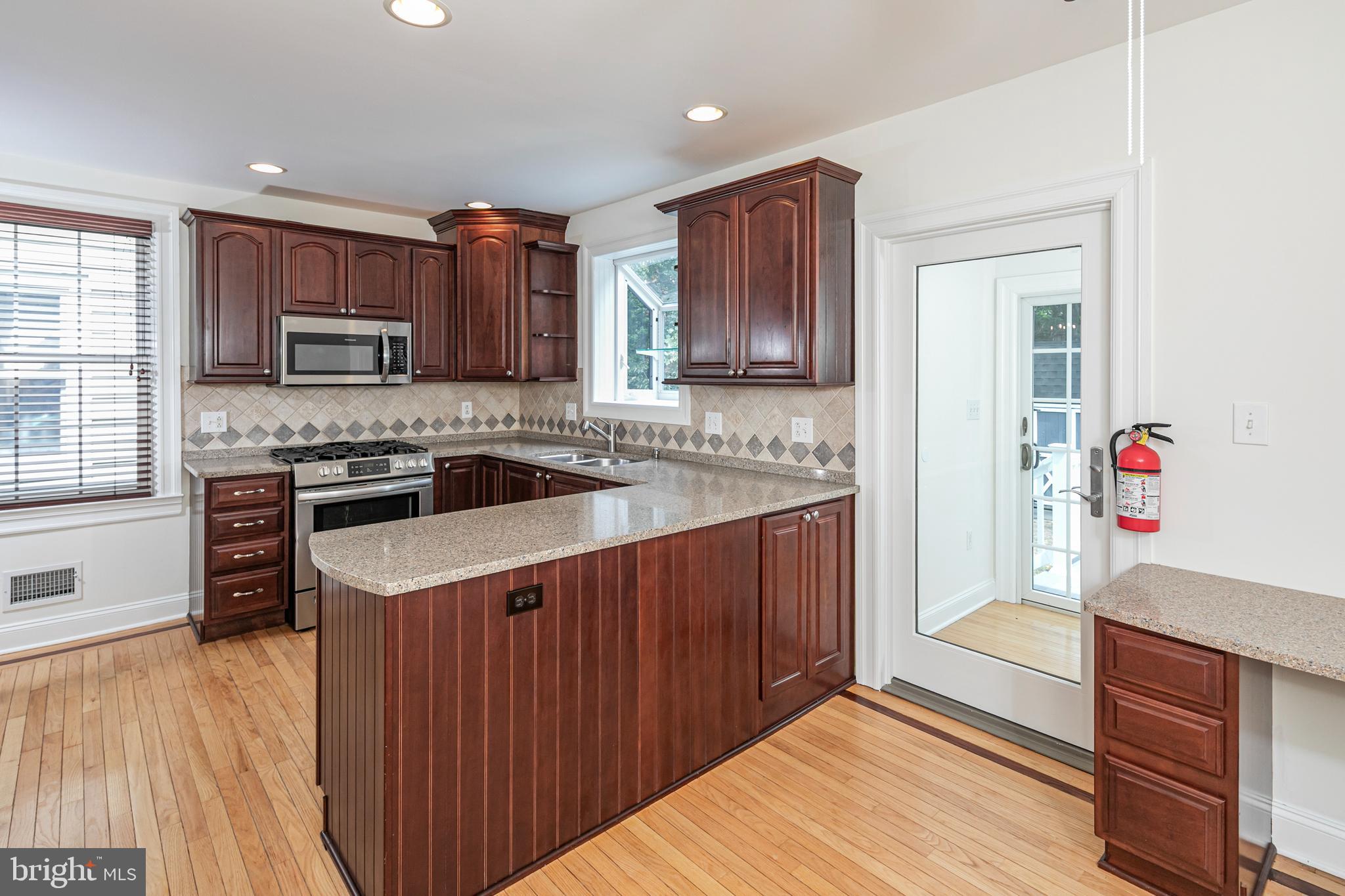 35 Maple Street Princeton, NJ 08542 - Photo 17 of 35 a kitchen with stainless steel appliances granite countertop a stove a sink dishwasher and a microwave oven with wooden cabinets