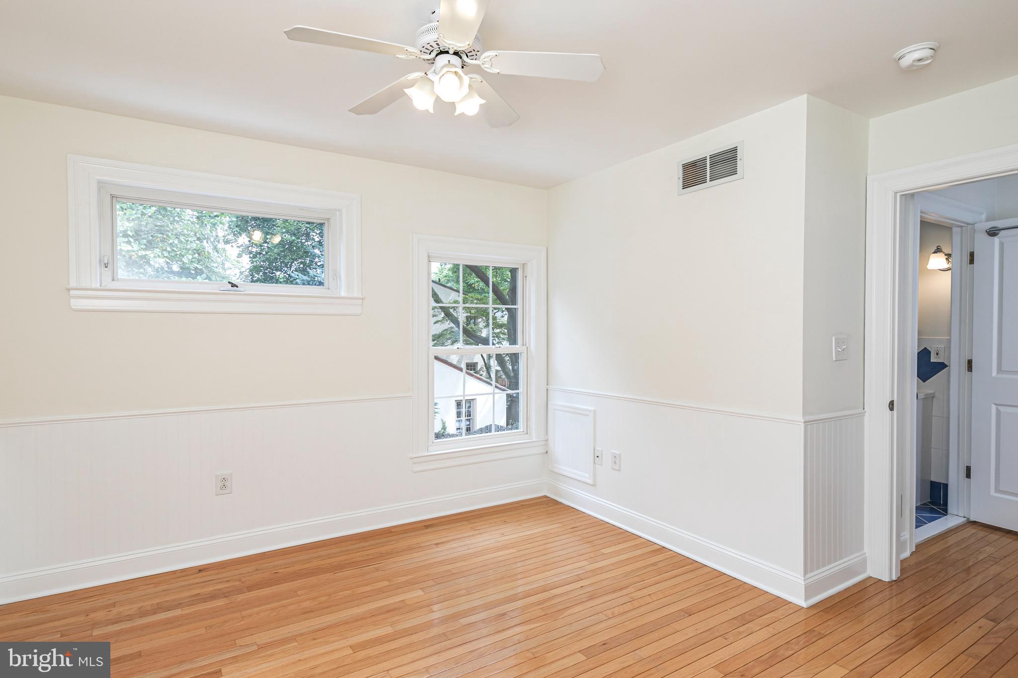 35 Maple Street Princeton, NJ 08542 - Photo 28 of 35 an empty room with wooden floor chandelier fan and windows