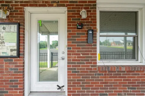 a view of a door with a brick wall