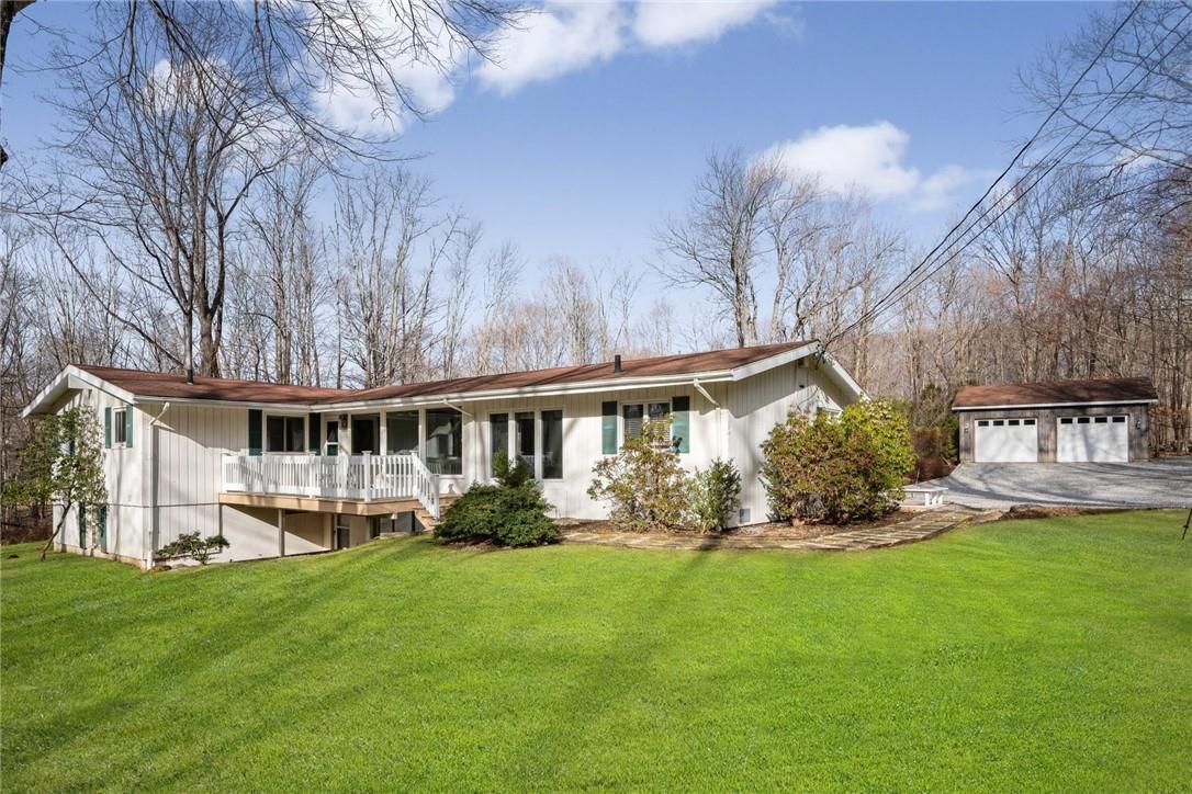 a front view of house with yard and green space