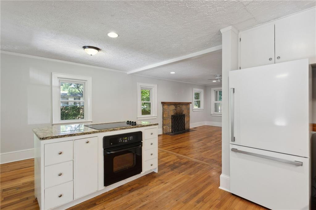 385 Sunset Drive Athens, GA 30606 - Photo 19 of 48 a kitchen with a sink a refrigerator and a stove top oven