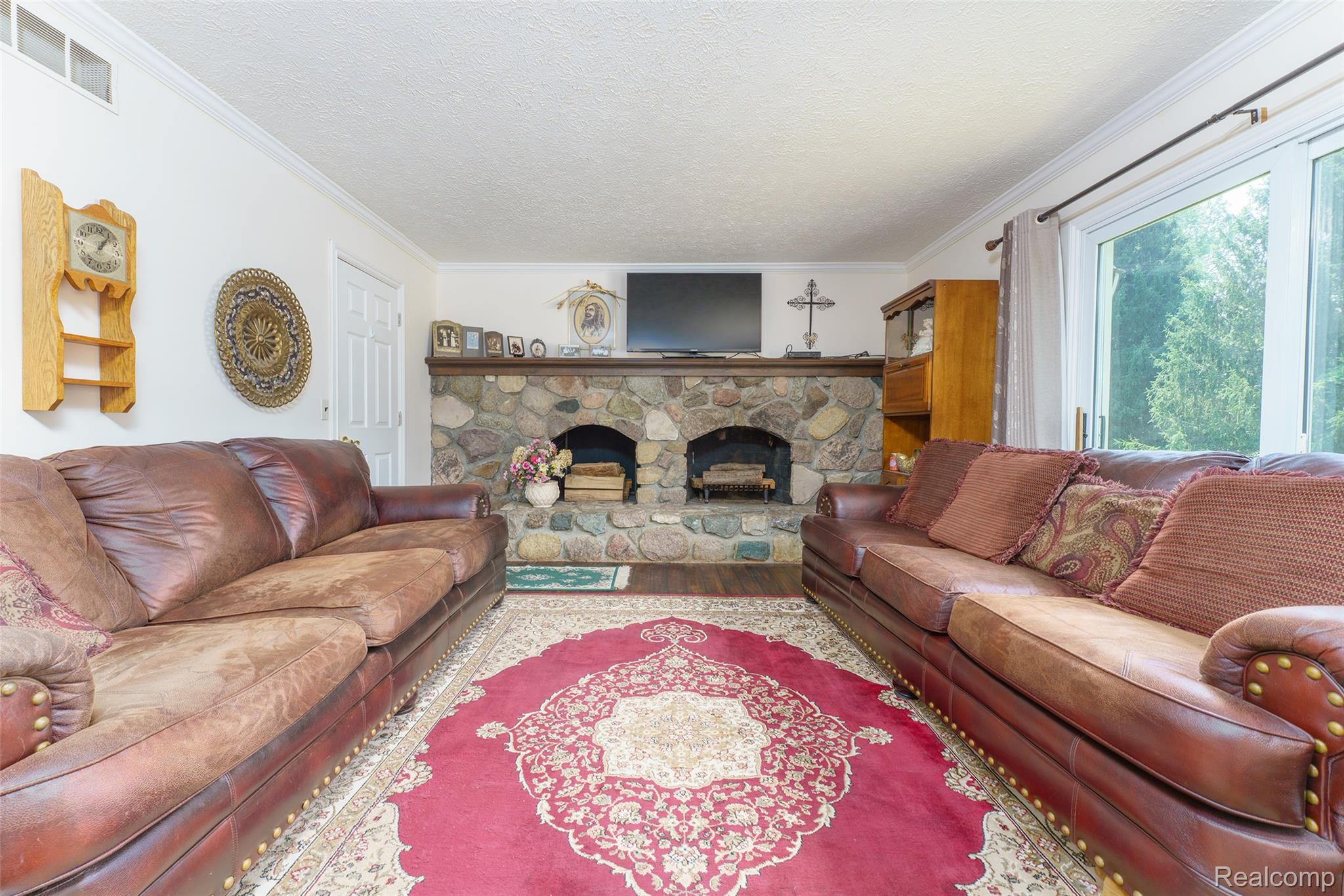 2220 Pheasant Run Road Howell, MI 48843 - Photo 16 of 34 family room with natural fireplace