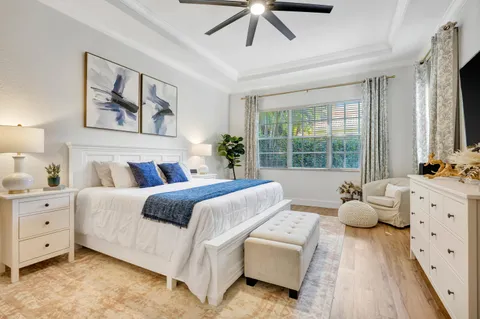 a bed room with a bed a television and a large window