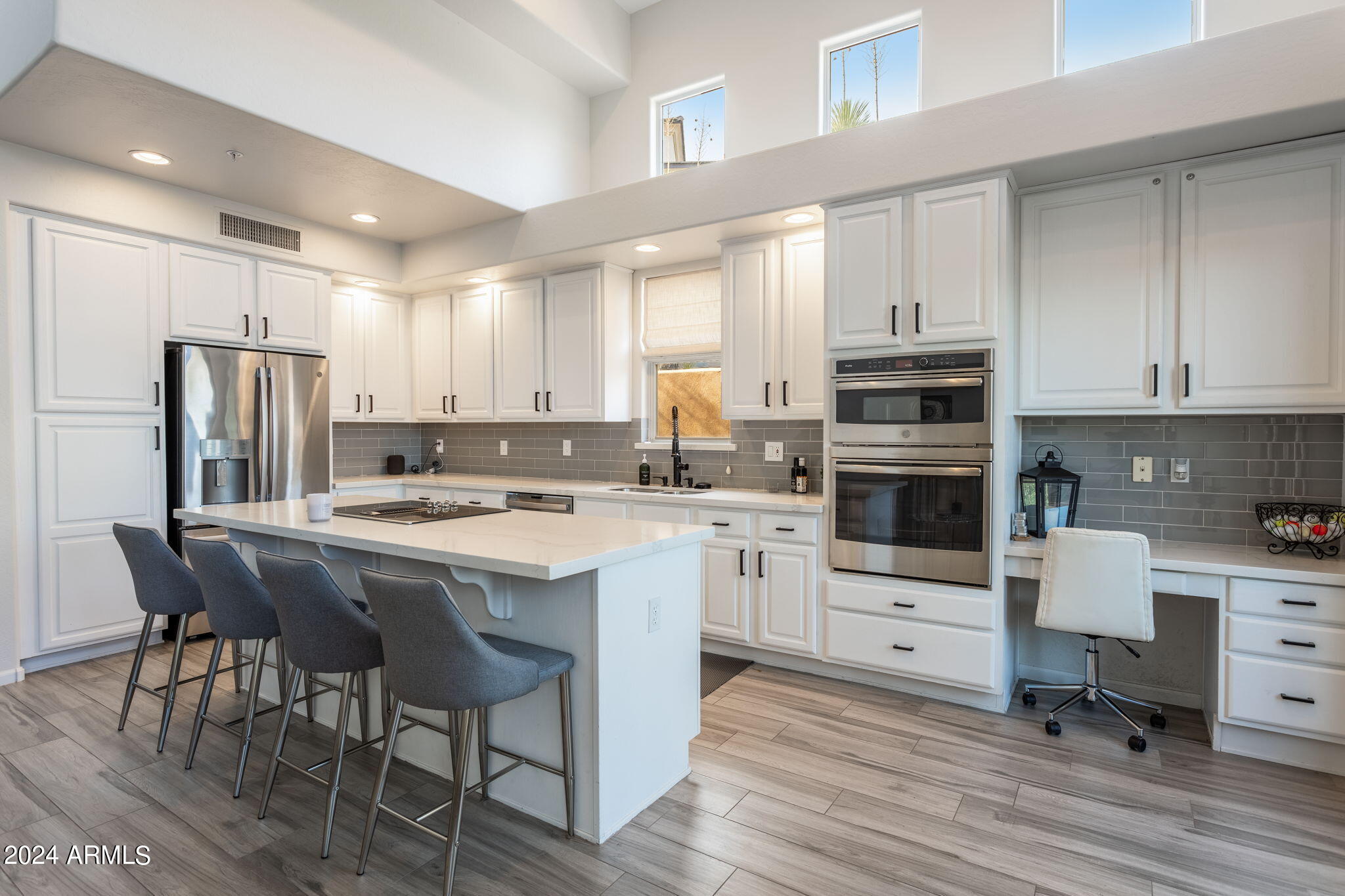 a kitchen with white cabinets and appliances