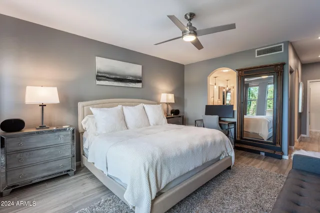 a bedroom with a large bed and a window