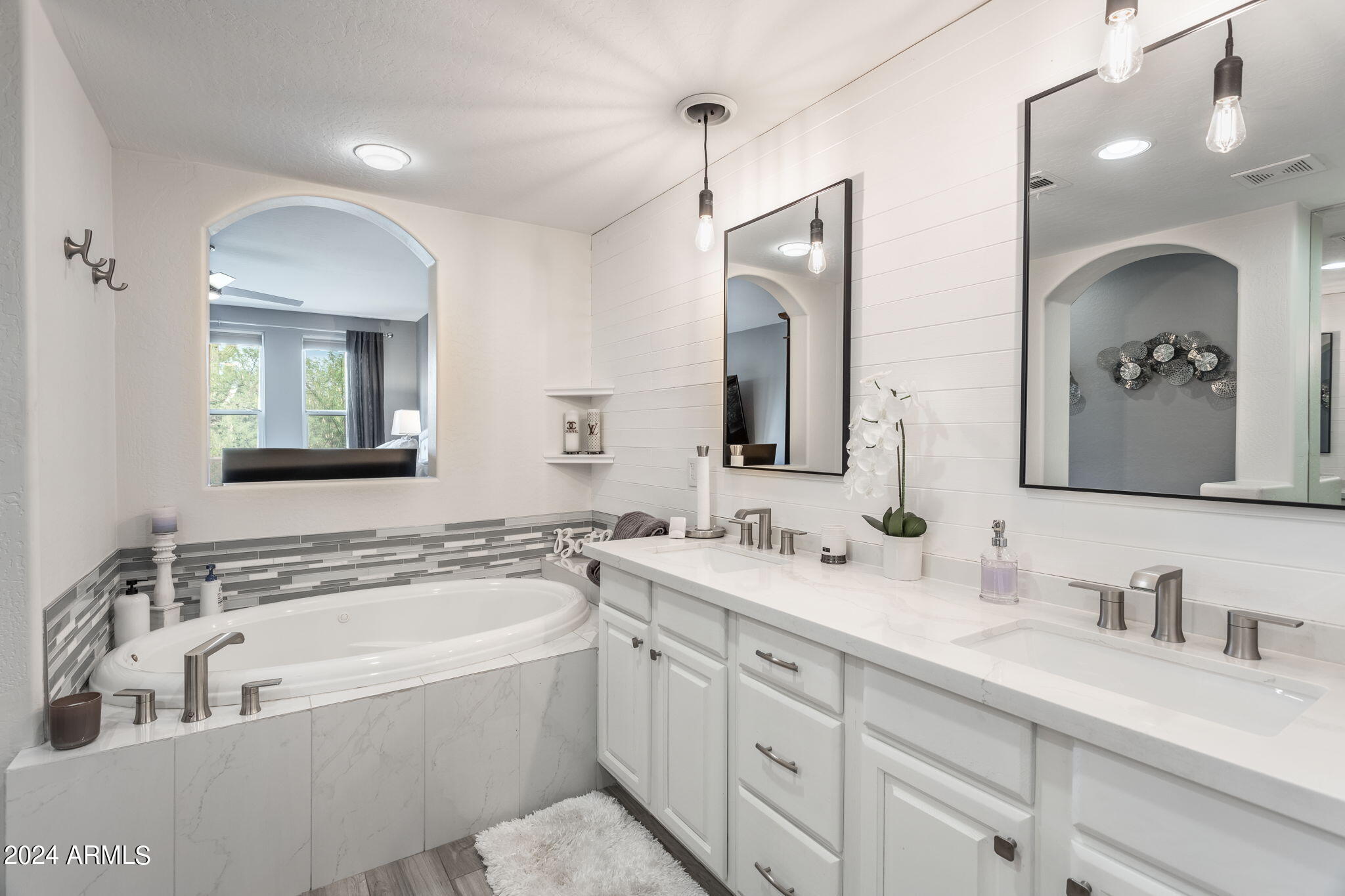 28990 North White Feather Lane, Unit 168 Scottsdale, AZ 85262 - Photo 17 of 36 a bathroom with a bathtub a double vanity sink and mirror