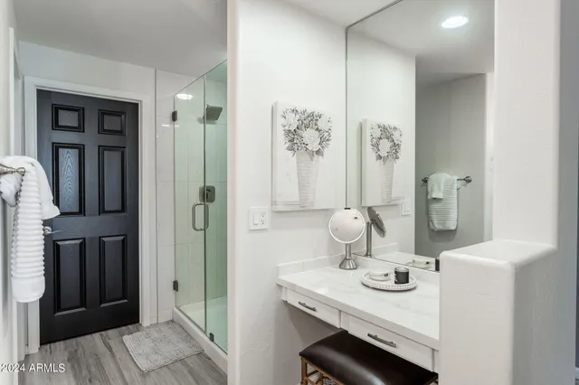 a bathroom with a bathtub a double vanity sink and mirror