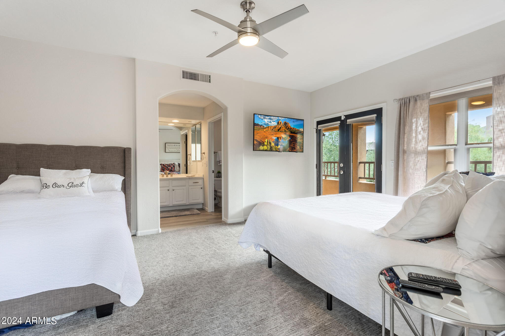 28990 North White Feather Lane, Unit 168 Scottsdale, AZ 85262 - Photo 23 of 36 a bedroom with a bed and a chandelier