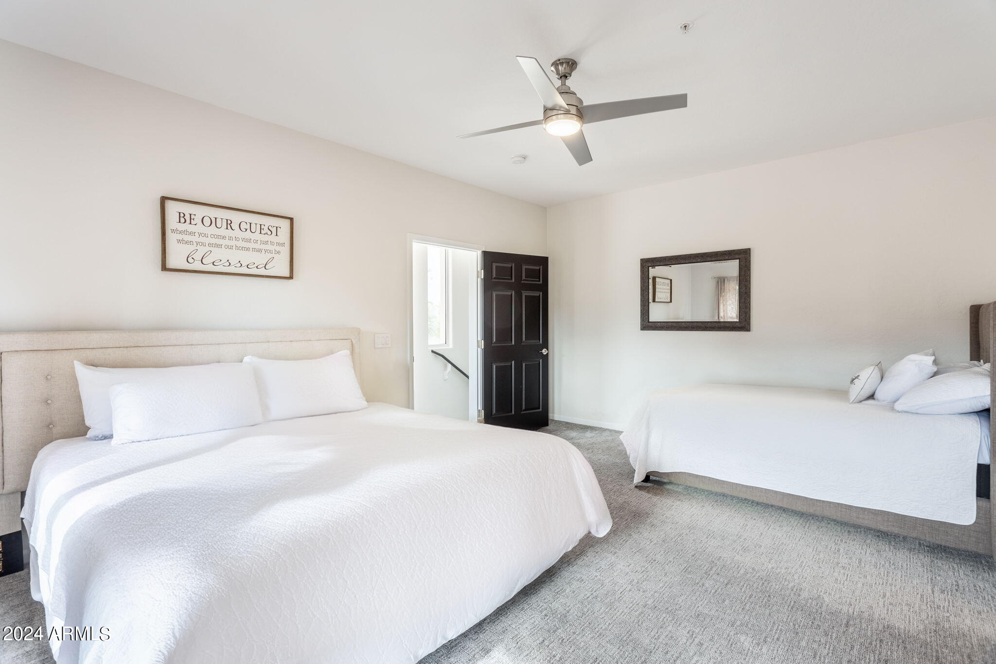 28990 North White Feather Lane, Unit 168 Scottsdale, AZ 85262 - Photo 24 of 36 a bedroom with a large bed and a chandelier