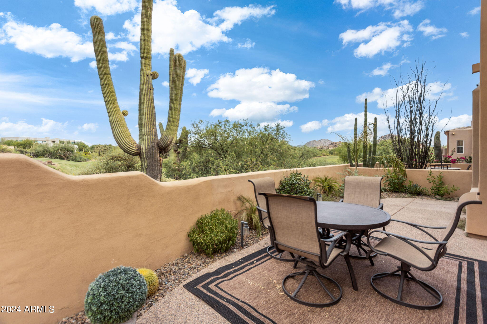 28990 North White Feather Lane, Unit 168 Scottsdale, AZ 85262 - Photo 3 of 36 a view of a patio with table and chairs with wooden fence