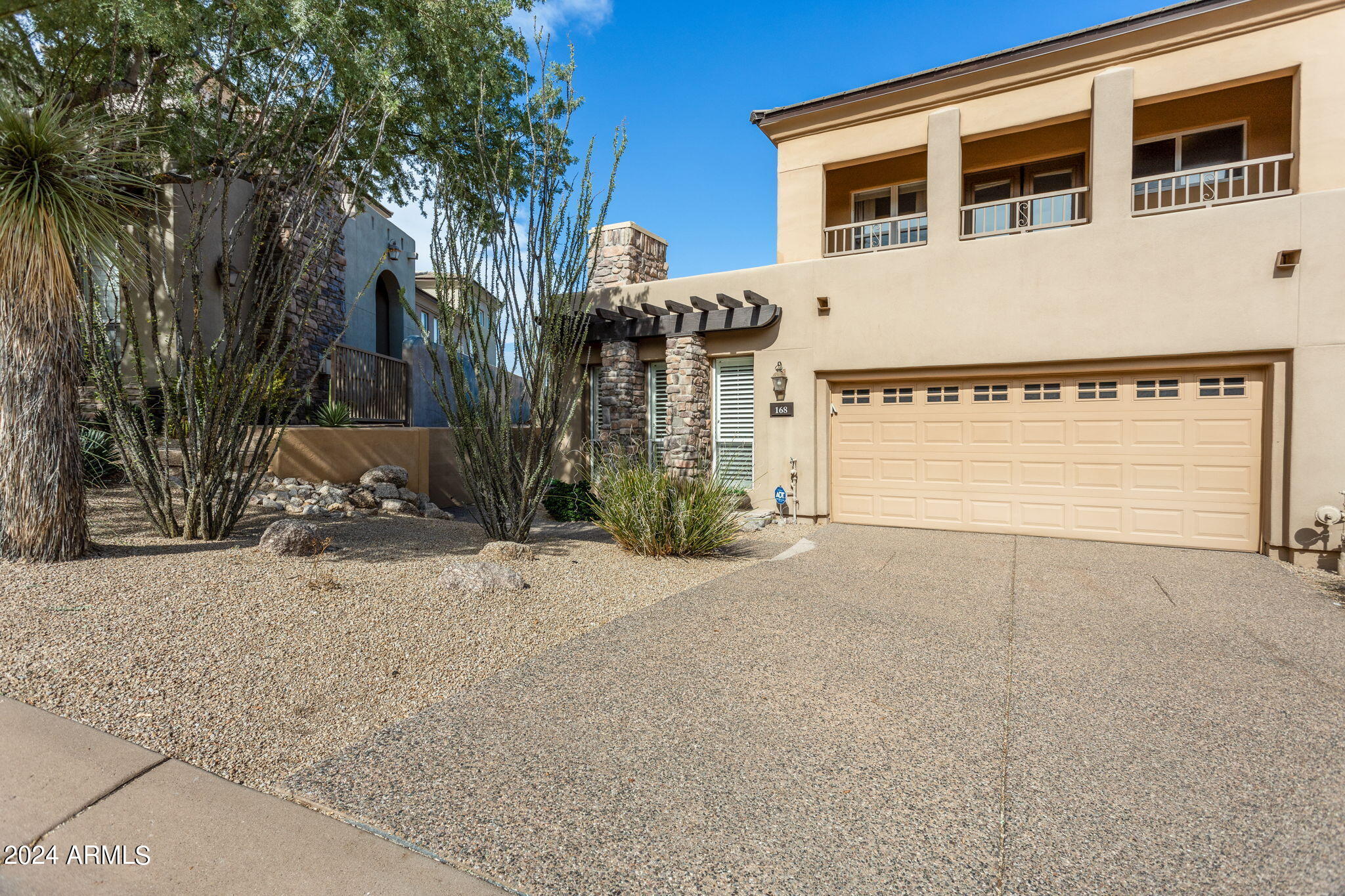28990 North White Feather Lane, Unit 168 Scottsdale, AZ 85262 - Photo 4 of 36 a front view of a house with a yard and garage