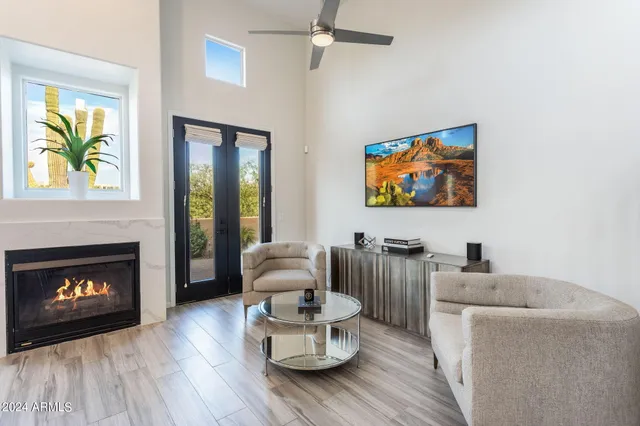 a kitchen with a stove a sink dishwasher a dining table and chairs with wooden floor