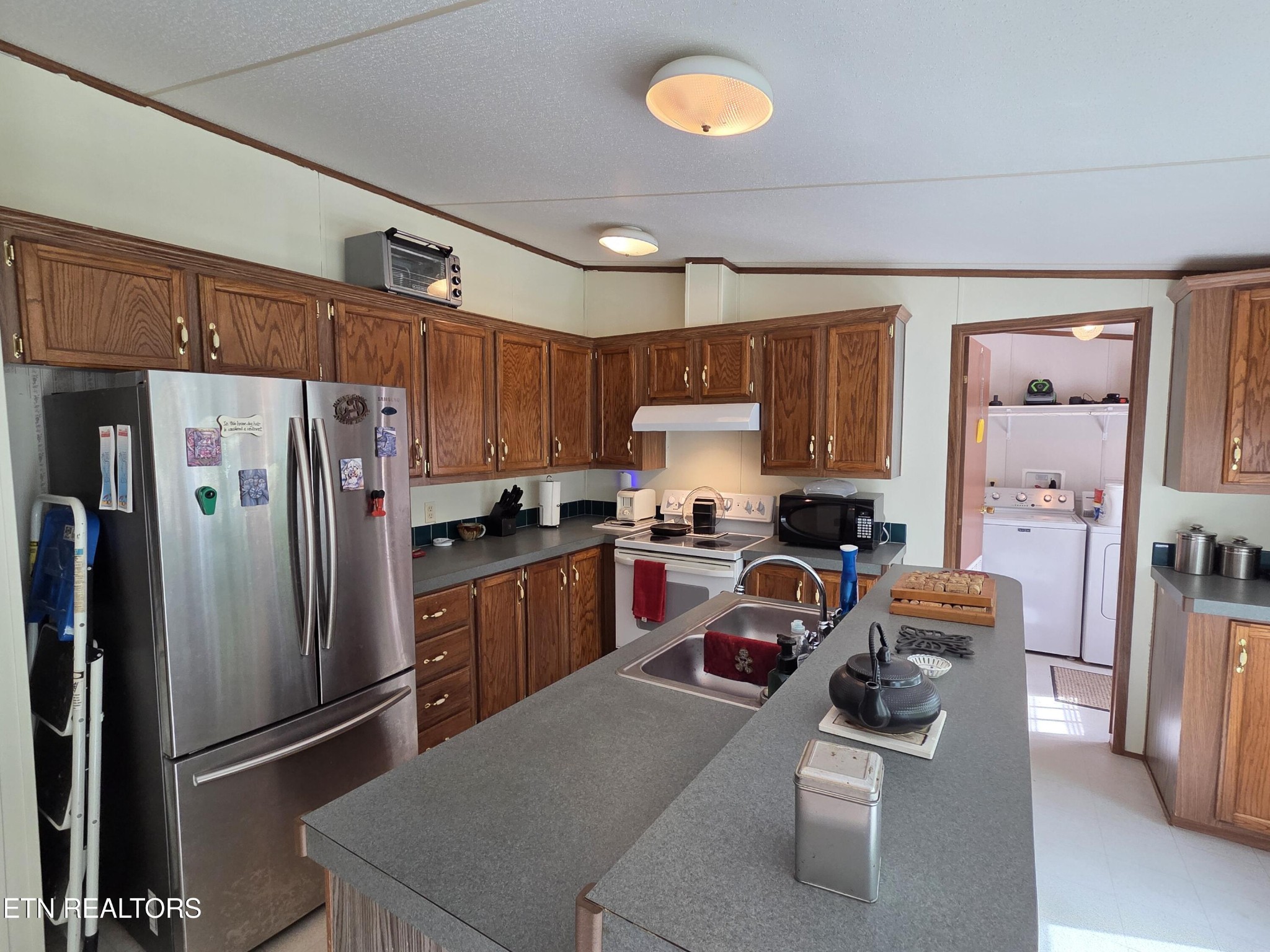 149 Carter Town Road Crossville, TN 38571 - Photo 12 of 30 a kitchen with stainless steel appliances granite countertop a refrigerator stove top oven a sink and dishwasher