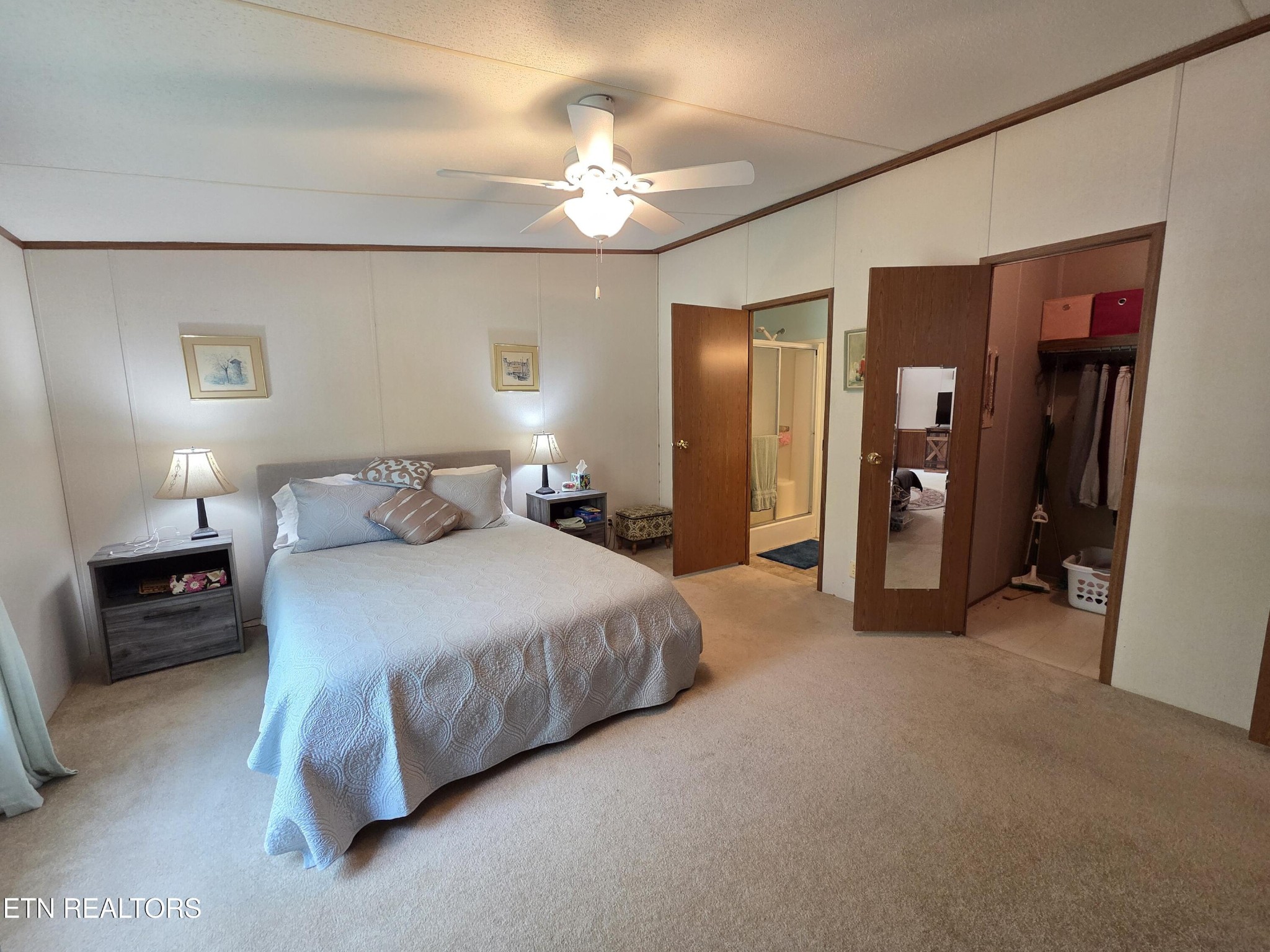 149 Carter Town Road Crossville, TN 38571 - Photo 21 of 30 a spacious bedroom with a bed and a chandelier