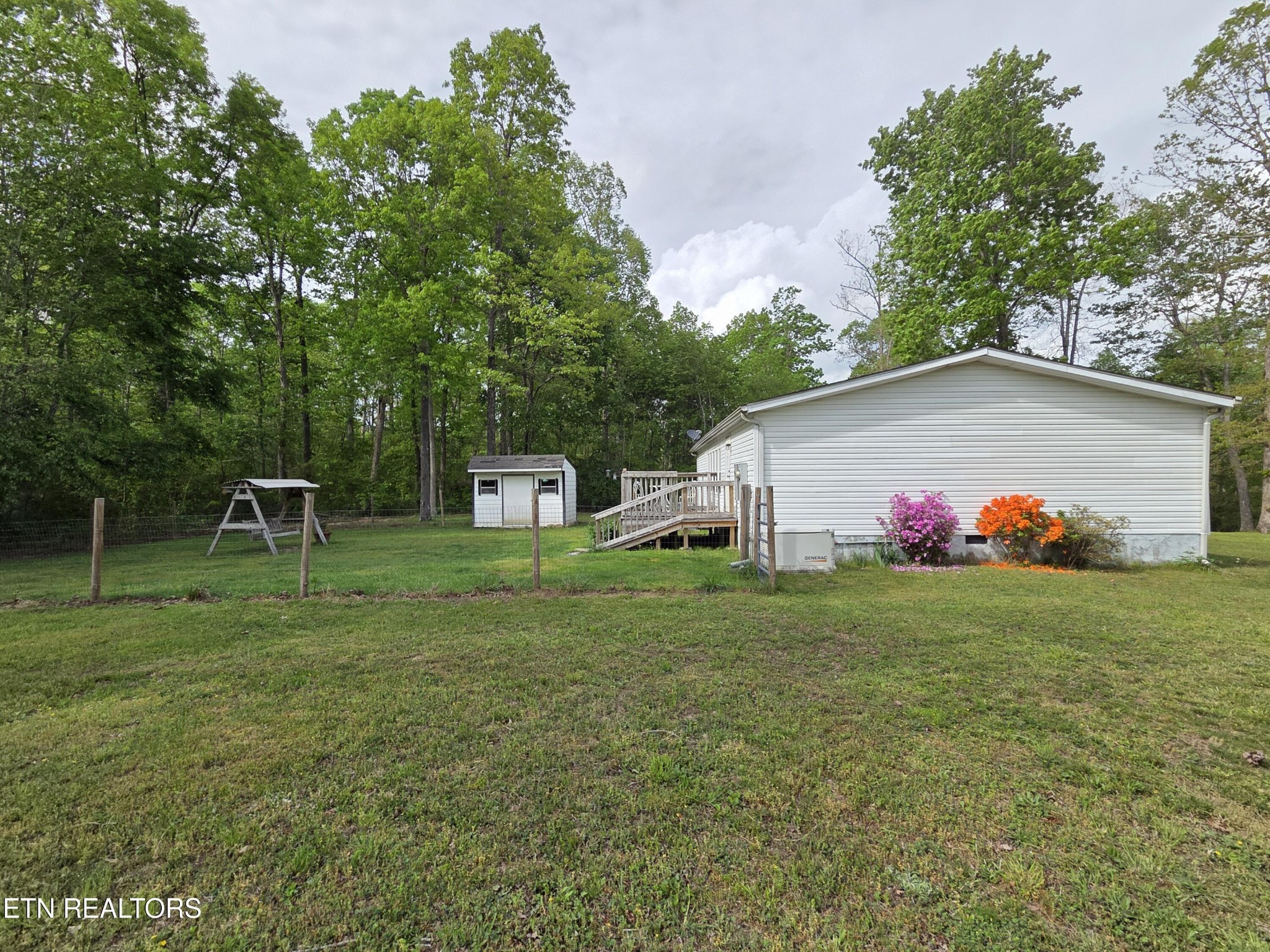149 Carter Town Road Crossville, TN 38571 - Photo 4 of 30 a backyard of a house with table and chairs