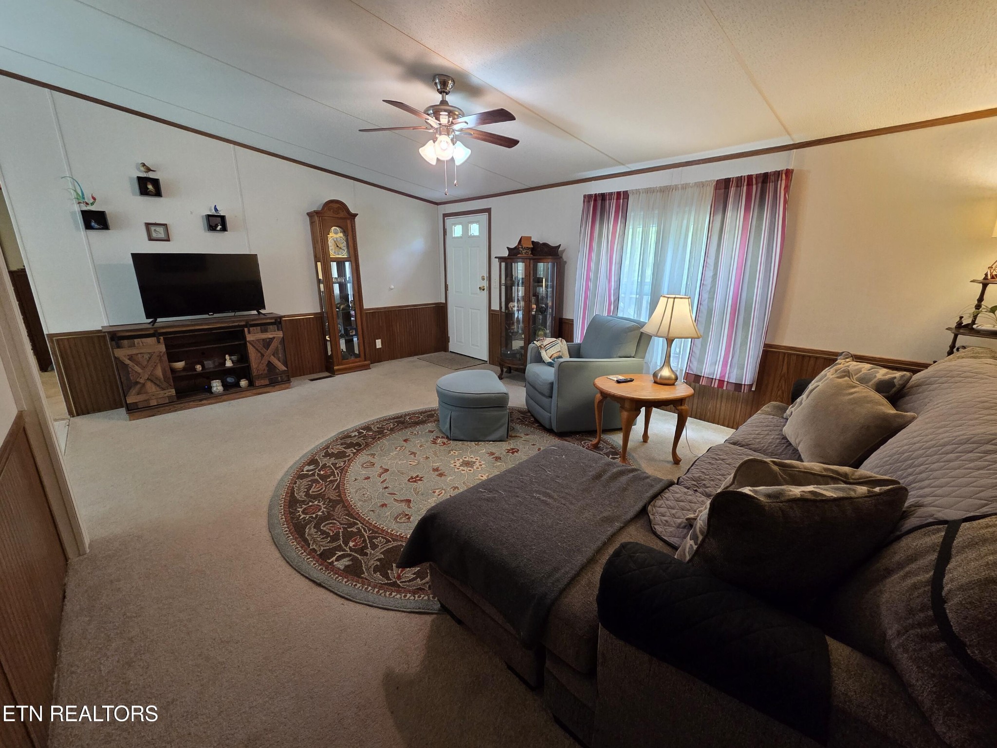 149 Carter Town Road Crossville, TN 38571 - Photo 8 of 30 a living room with furniture a large window and flat screen tv