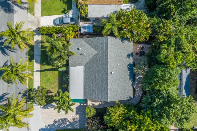 an aerial view of a house with a yard