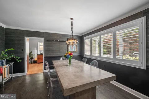 a view of a hallway with furniture and a window